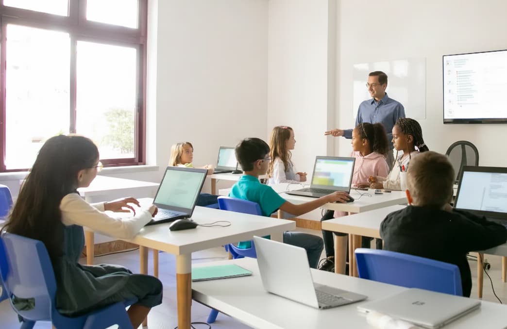 A teacher describes a concept to his classroom, showing how operational choices set some schools apart